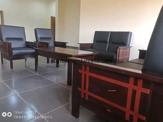 Reception suite with upholstered seating and timber tables