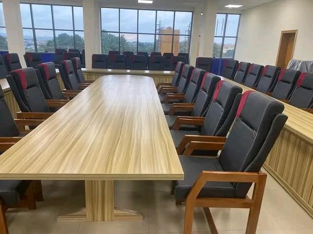 Senate chamber with a long timber conference table and upholstered chairs
